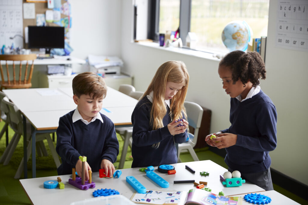 elevated-view-of-three-primary-school-kids-working