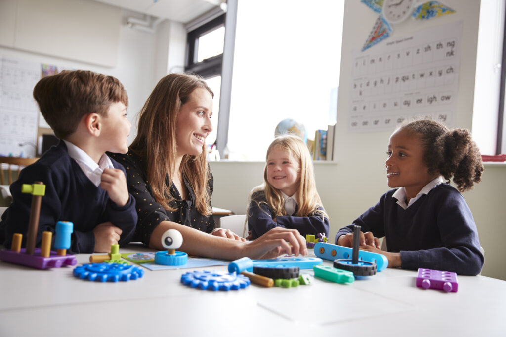 teacher-with-primary-school-children-working