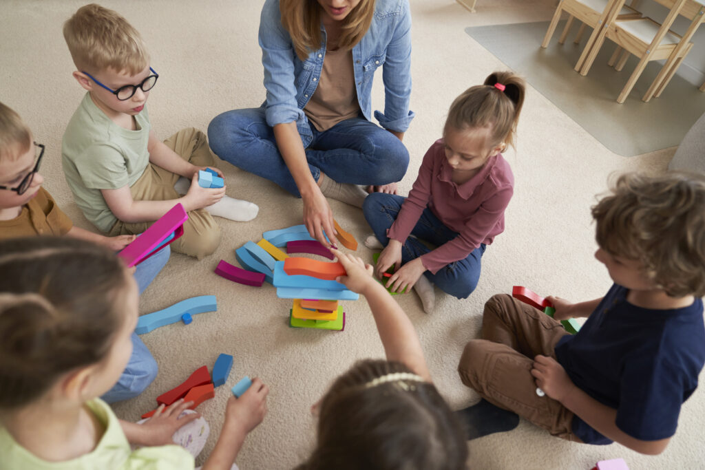 top-view-of-children-playing-with-toy-blocks